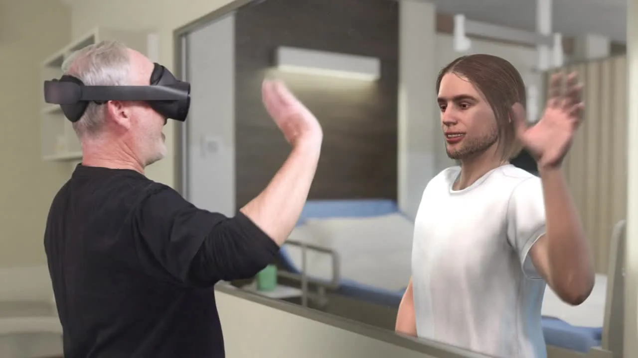 A man wearing a mixed-reality headset raises his hands, mirrored by a long-haired avatar, in a simulated hospital room