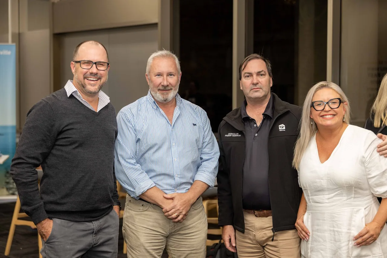 Four guests stand together at the 18 July 2024 public launch of PTR's VR Training Library, a set of ready-to-run VR titles, held in Townsville.