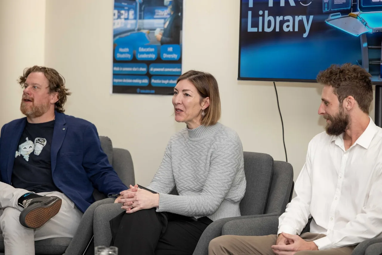 Panellists sit in armchairs beneath a PTR Library screen, part of the expert panel at the 18 July 2024 launch of PTR's VR Training Library in Townsville.