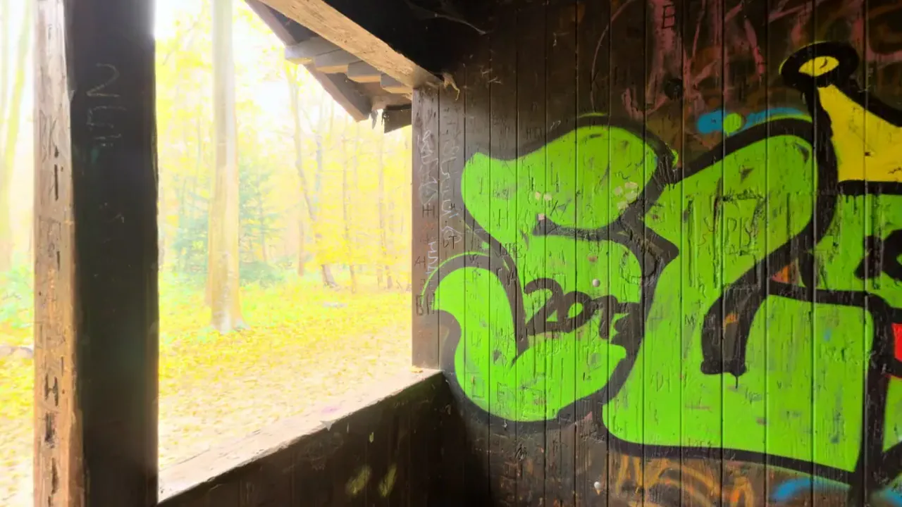 A panoramic view inside a graffiti-covered shelter, a 360 environment that can be looked around in a browser or a headset.