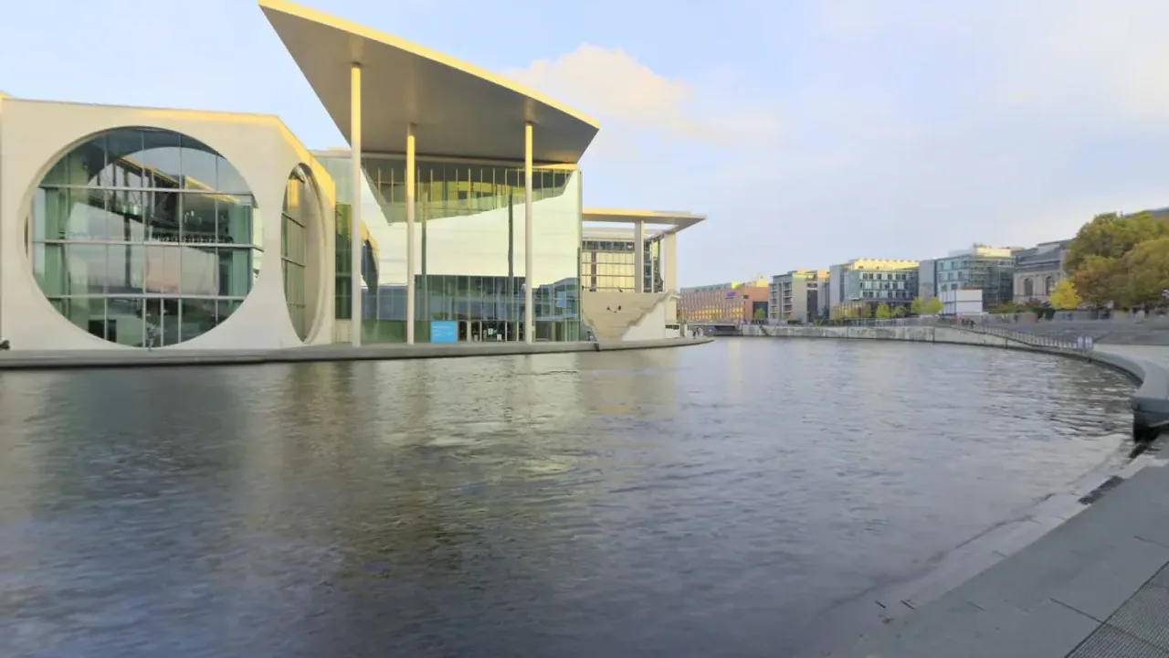 A street among modern buildings. A looping 360 scene built as a Fast Builds 360 experience, shown flat.