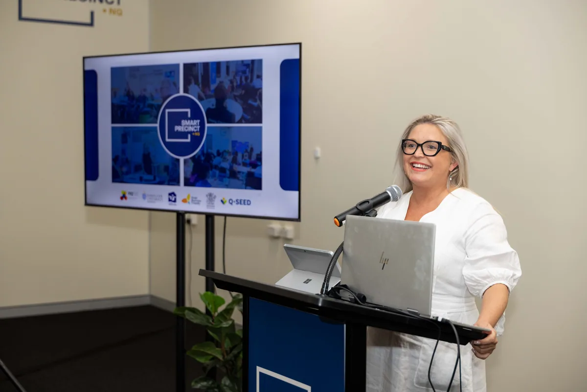 The host opens the evening at the lectern. PTR VR Library public launch at Smart Precinct NQ, Townsville, 18 July 2024.