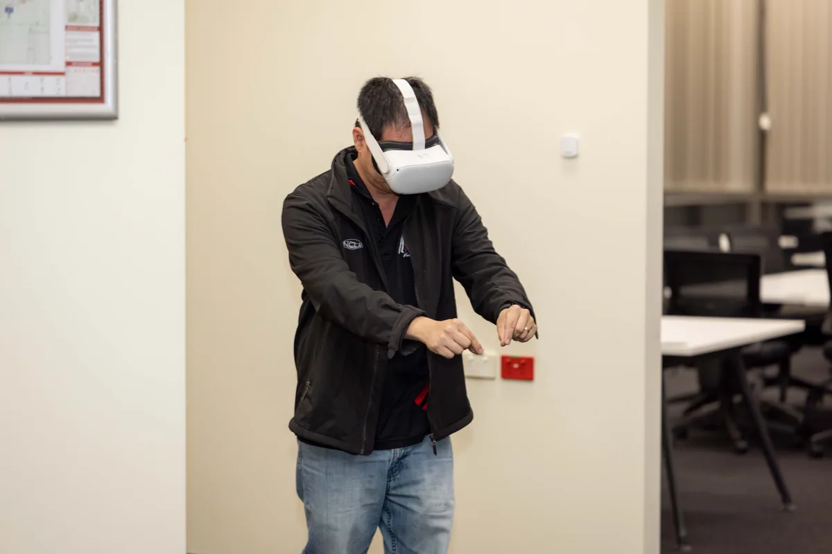 Reaching out inside a virtual scene. PTR VR Library public launch at Smart Precinct NQ, Townsville, 18 July 2024.