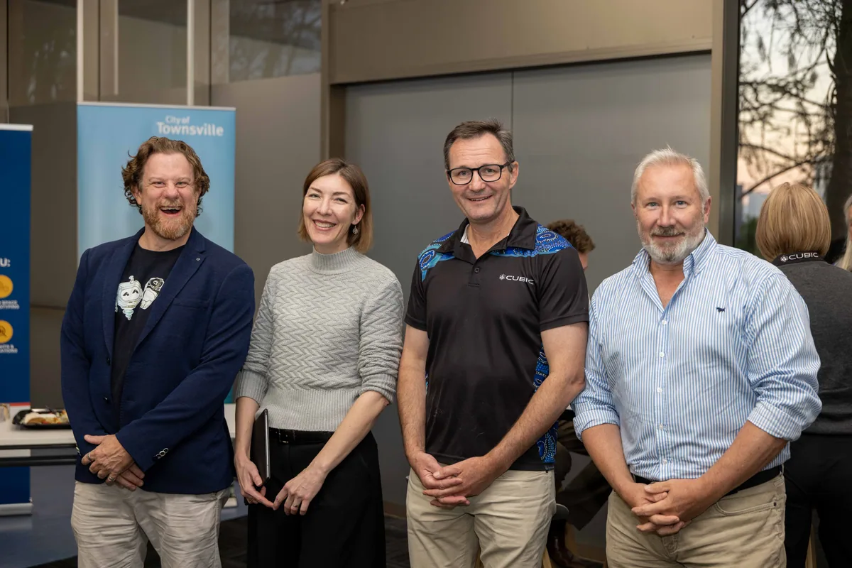 Simon Lowe with guests by the banners. PTR VR Library public launch at Smart Precinct NQ, Townsville, 18 July 2024.