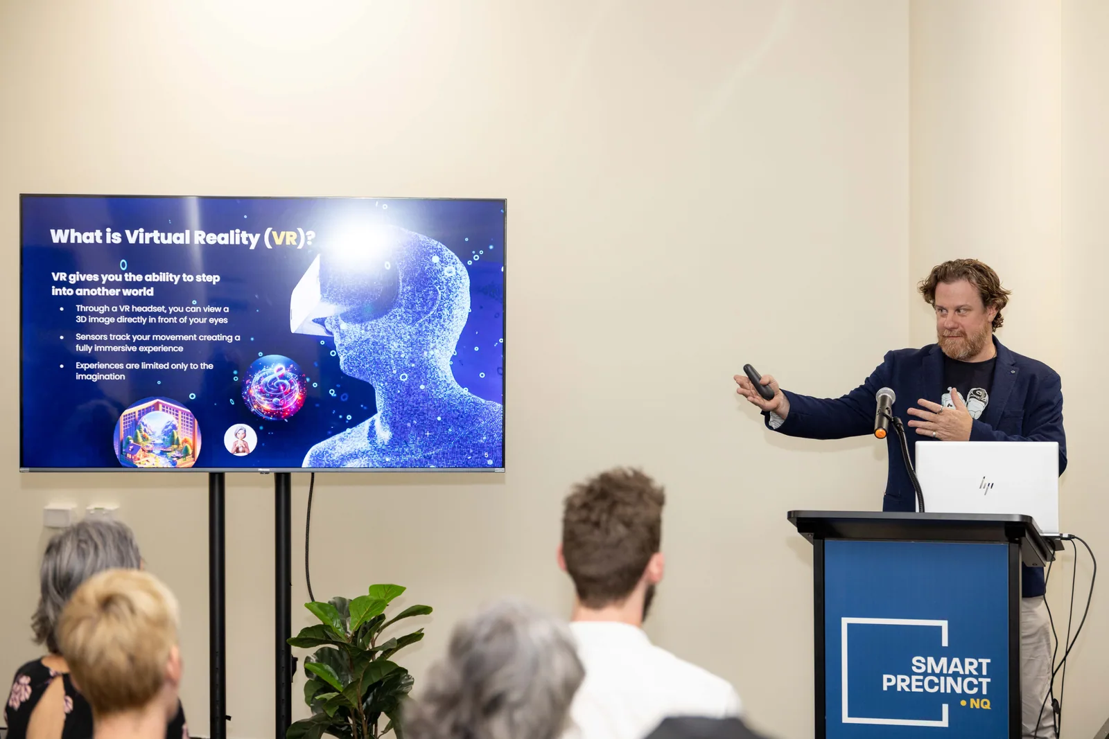Simon Lowe speaking beside the virtual reality slide. PTR VR Library public launch at Smart Precinct NQ, Townsville, 18 July 2024.