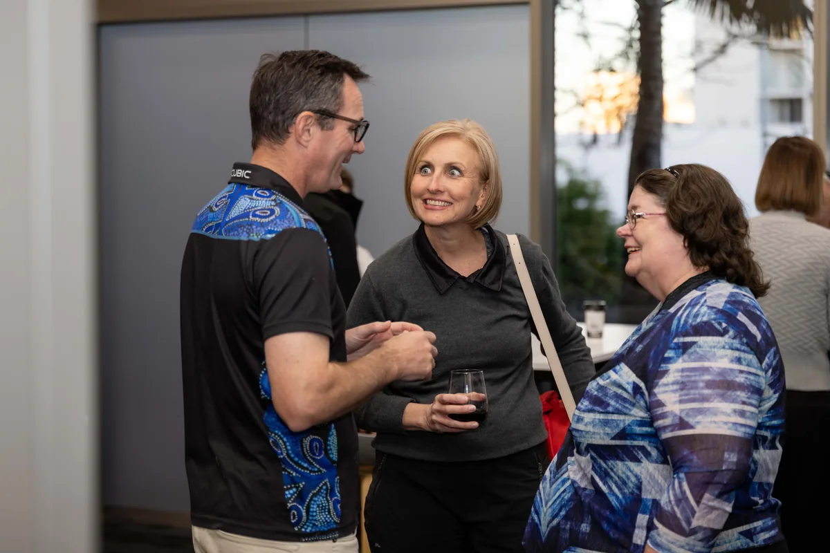 Three guests laughing before the welcome. PTR VR Library public launch at Smart Precinct NQ, Townsville, 18 July 2024.