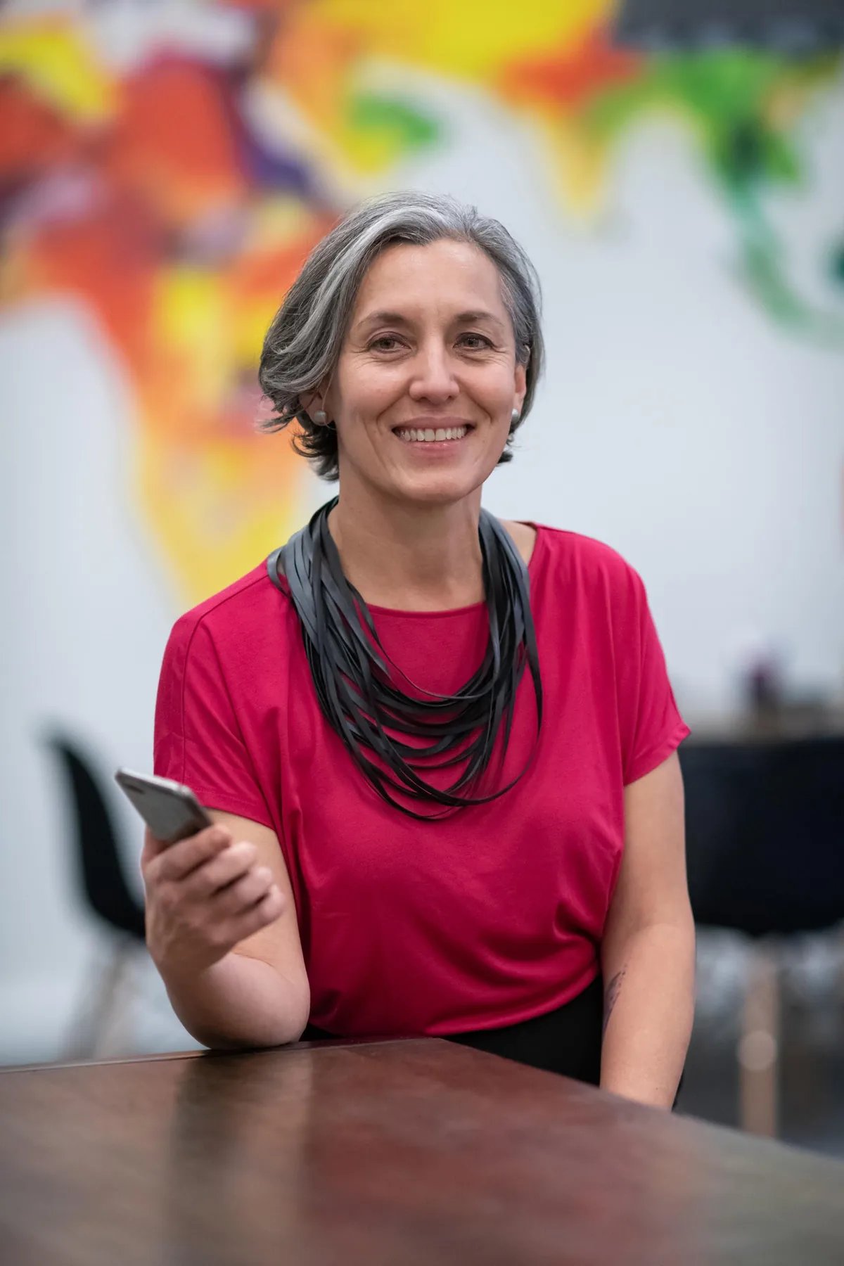 Leonie Sanderson, PTR's co-founder, seated at a table.
